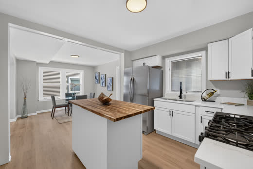 Kitchen island and quartz countertops opening to dining room, 9205 S Utica Ave Evergreen Park