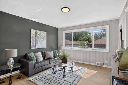 Living room with picture window and accent wall at 9205 S Utica Ave, Evergreen Park