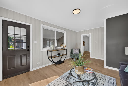 Front entry and living room with paneled walls at 9205 S Utica Ave, Evergreen Park
