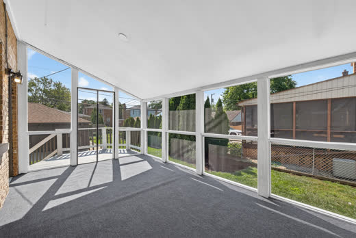 Bright screened-in porch with backyard views at 9205 S Utica Ave, Evergreen Park