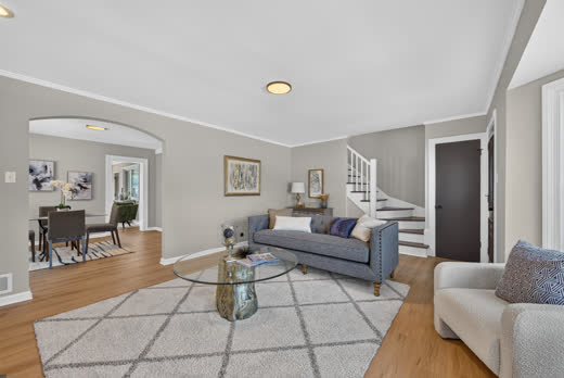 Living room with arched dining room entry and staircase in renovated Evergreen Park home