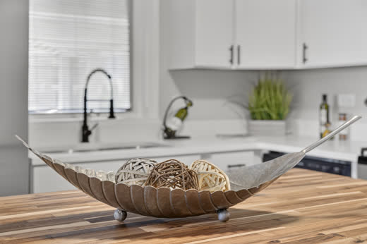 Butcher block island detail in renovated white kitchen at 9205 S Utica Ave
