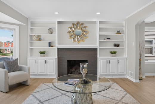 Living room with fireplace and white built-in shelving at 9205 S Utica Ave, Evergreen Park