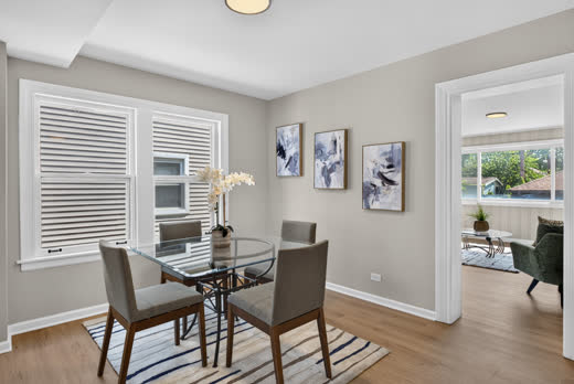 Staged dining room opening to sunroom at 9205 S Utica Ave, Evergreen Park